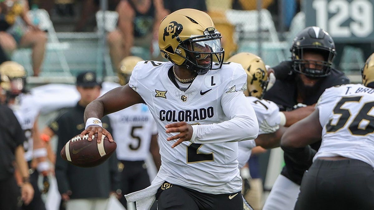 Shedeur Sanders looks to pass the football