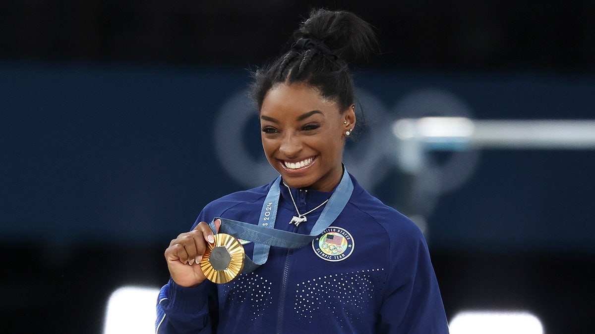 Simone Biles holds the gold