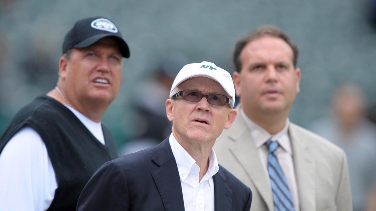 Mike Tannenbaum, Rex Ryan and Woody Johnson look up