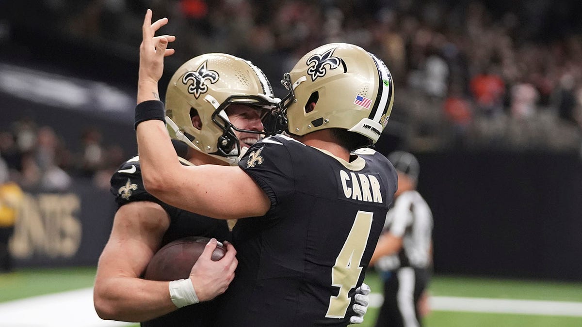 Taysom Hill and Derek Carr celebrate