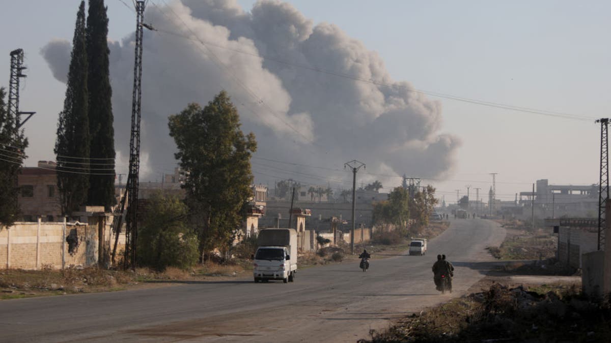 Fighters enter the Rashidin district on the outskirts of Aleppo on their motorbikes during fighting on Nov. 29, 2024.