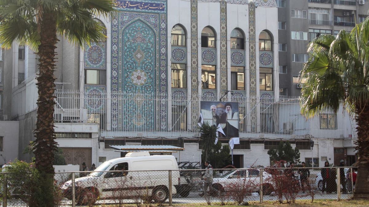 Rebel fighters stand near the Iranian embassy in Damascus, Syria, Dec. 8, 2024.