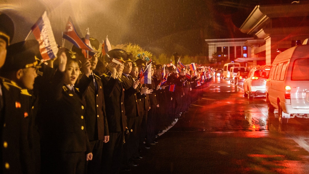 North Koreans waving flags