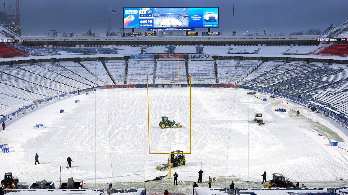 Highmark Stadium workers on the field