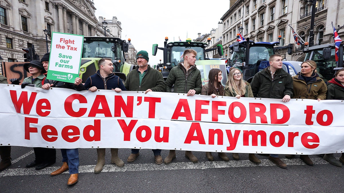 demonstrators hold signs saying 'We can't afford to feed you anymore'