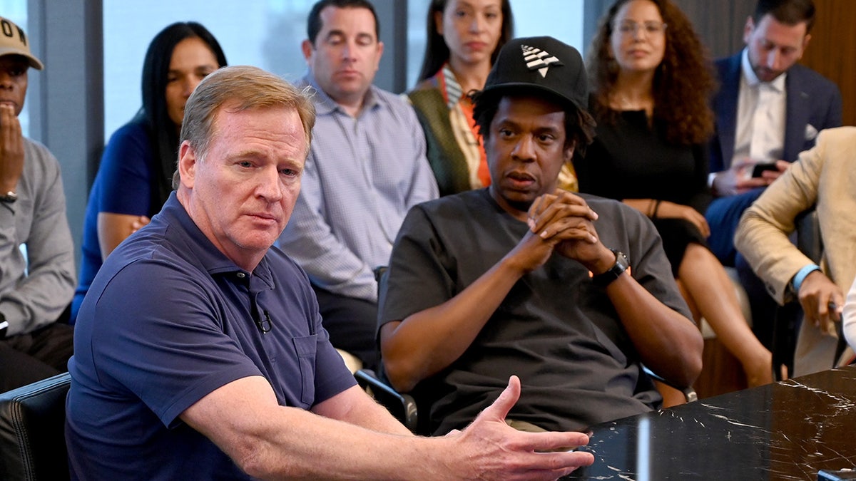 Roger Goodell and Jay Z attend a meeting