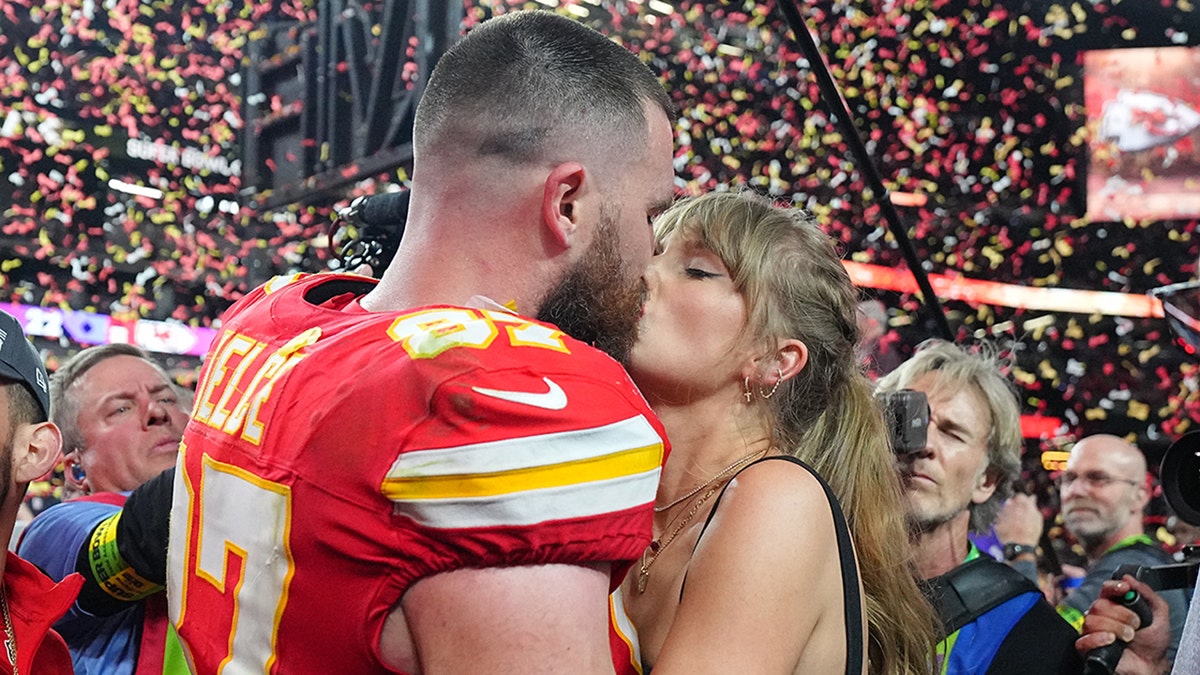 Travis Kelce kisses Taylor Swift after winning the Super Bowl as confetti falls to the ground