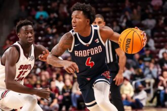 Young college basketball fan delays game after adorably storming the court: ‘Don’t know whose child that is’