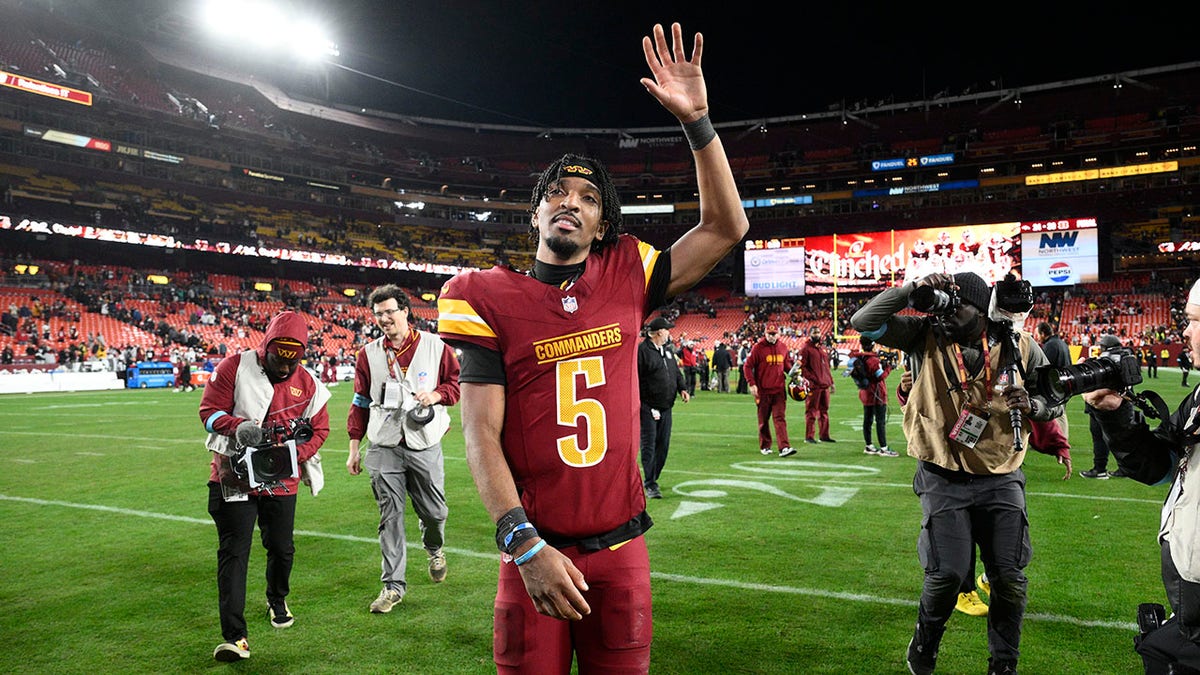 Jayden Daniels waves to crowd