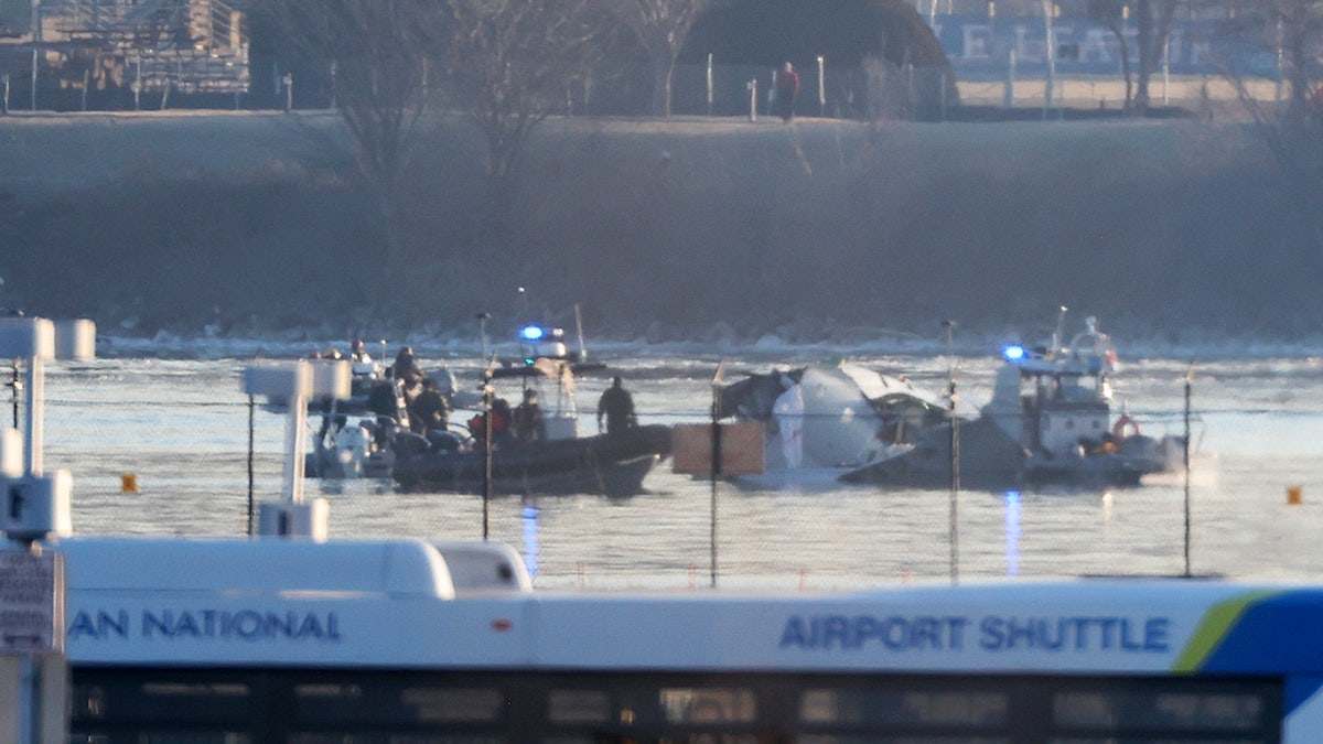 Emergency response units search the crash site of the American Airlines plane on the Potomac River