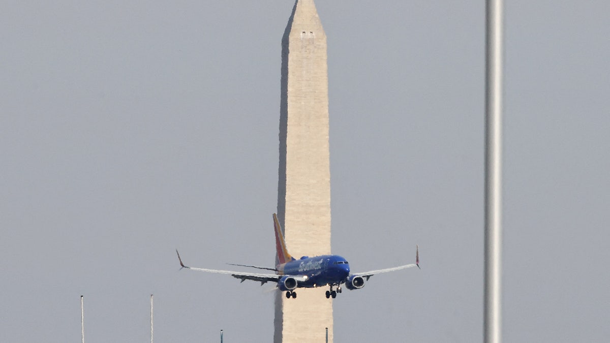 A plane flies near Ronald Reagan Washington National Airport