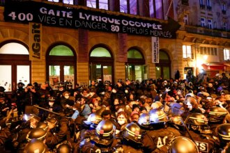 Hundreds of migrants evicted from Paris theater after squatting there for months