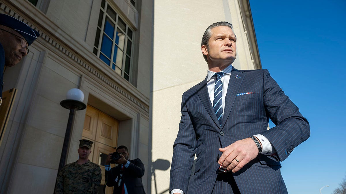 Hegseth outside Pentagon with band honoring fallen soldier