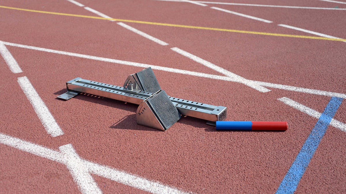 Baton and starting block on track