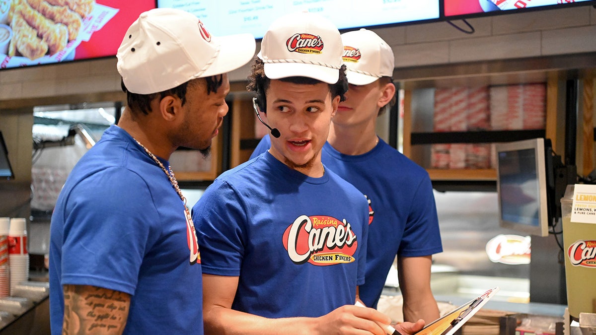 Walter Clayton Jr speaks to Alijah Martin at Raising Cane's