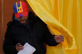Romanians vote in cliffhanger election as tensions continue to rise