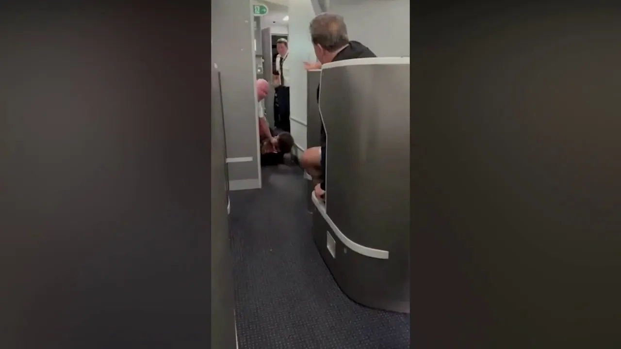 American Airlines passenger restrained, knocked to floor while barging into cockpit: video