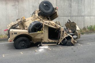 Two injured after military vehicle crashes over highway retaining wall, plunges 30 feet onto road below