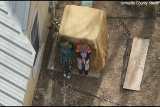 Boys, ages 7 and 9, seen in armed standoff receiving assistance from deputies
