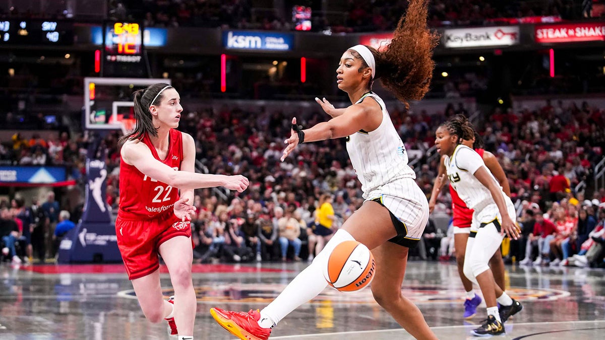Caitlin Clark makes pass past Angel Reese