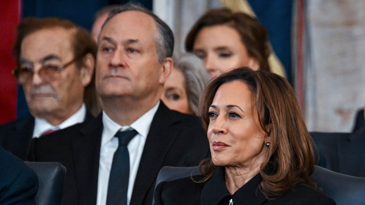 Former Vice President Kamala Harris, right, and Doug Emhoff listen listen as President Donald Trump speaks after taking the oath of office at the 60th Presidential Inauguration in the Rotunda of the U.S. Capitol in Washington, Monday, Jan. 20, 2025.