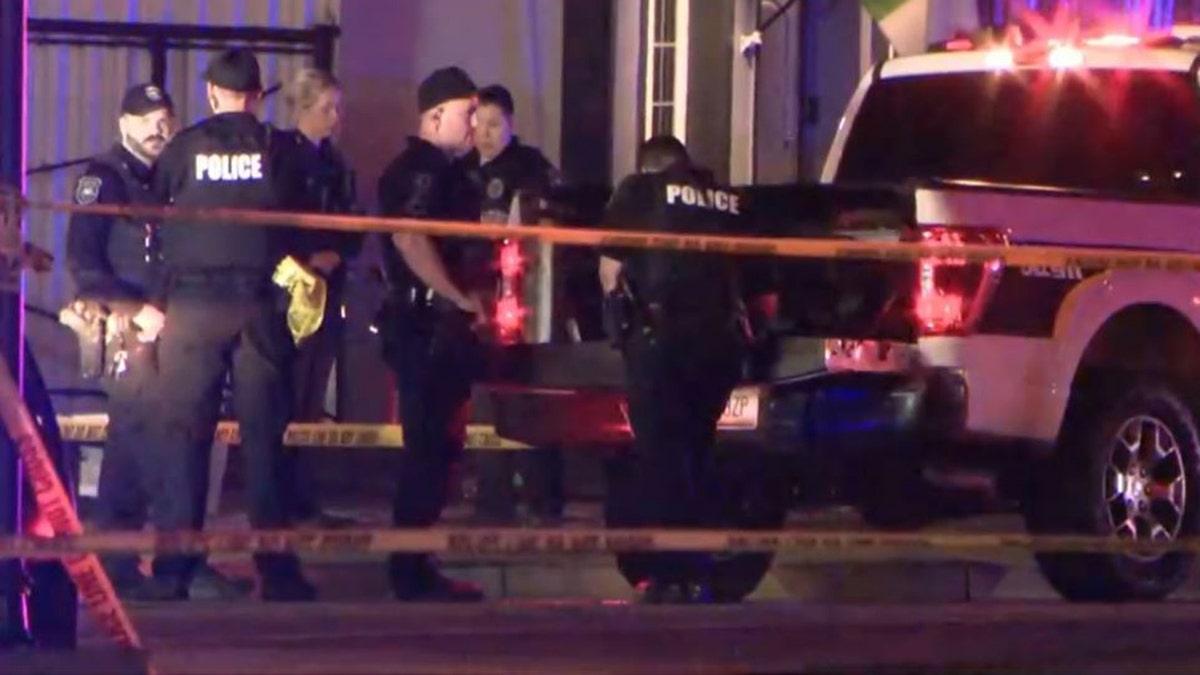 police officers and police vehicles at the shooting scene