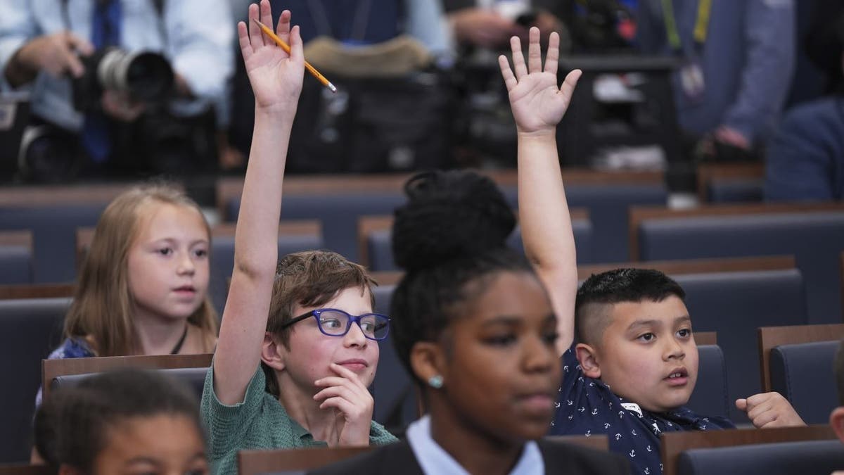 Children raised their hands as White House press secretary Karoline Leavitt speaks during a briefing for "Take Our Sons and Daughters To Work Day" at the White House, Tuesday, May 20, 2025, in Washington. (AP Photo/Evan Vucci)