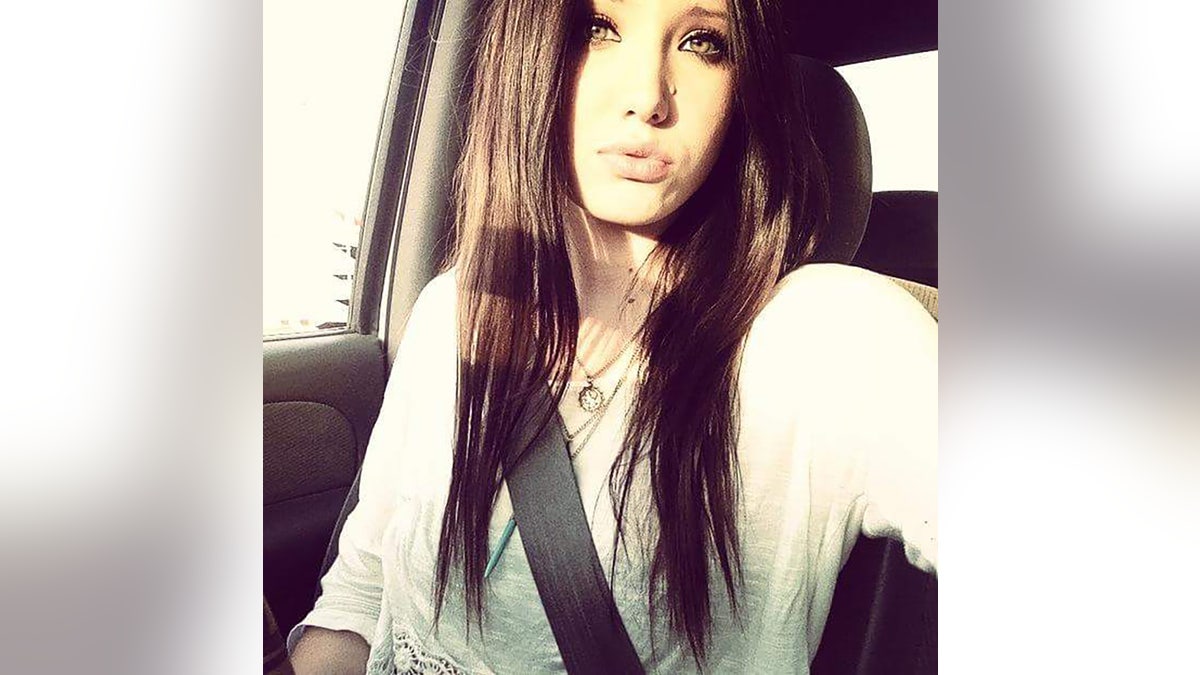 Baylee Despot giving a kissing selfie from inside her car.