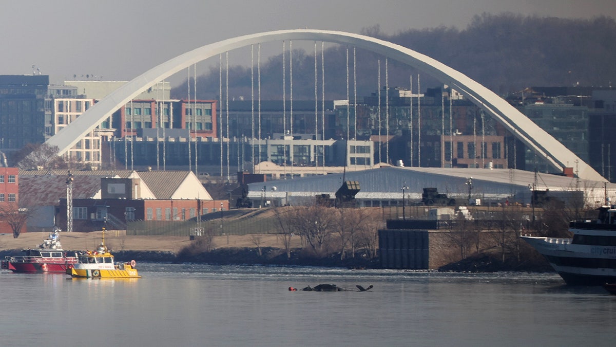 Emergency response units search the crash site of the American Airlines plane on the Potomac River
