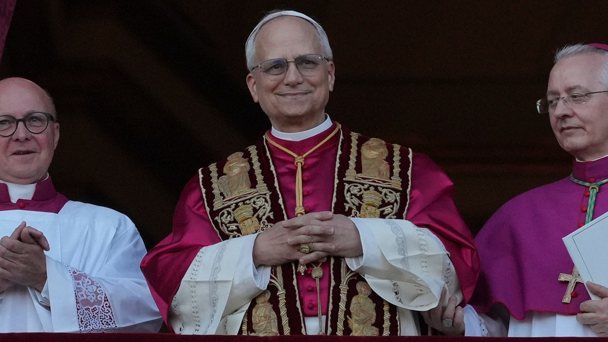 Pope Leone XIV smiling with his hands folded