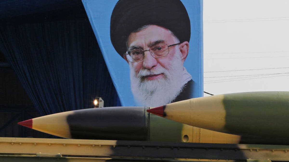 Iran military parade with missiles and a portrait of Iran's Supreme Leader Ayatollah Ali Khamenei