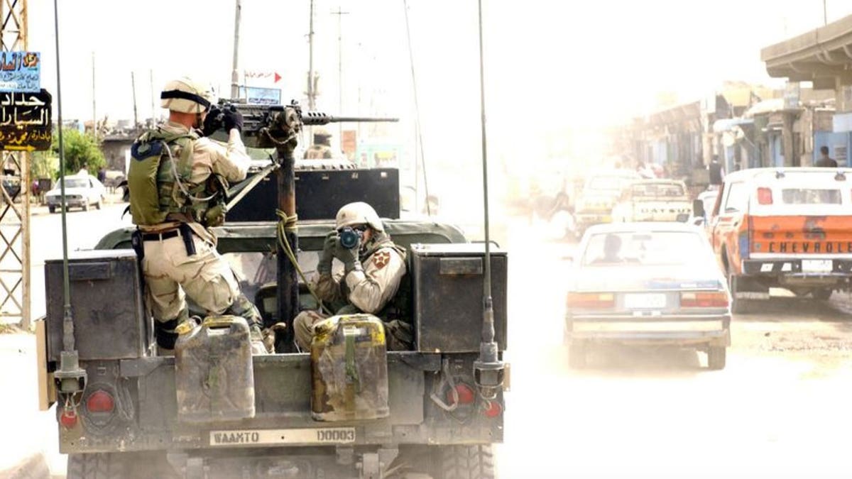 U.S. soldiers in a vehicle driving through Iraq