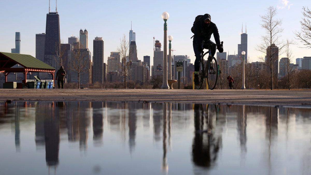 Photo showing biker riding in front of Chicago skyline