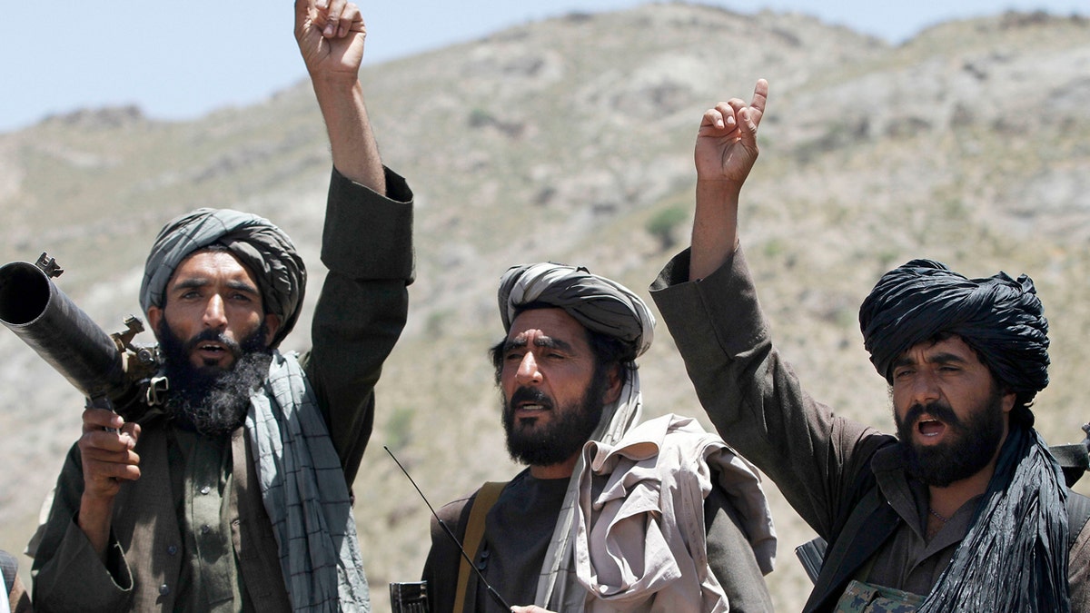 Taliban fighters react to a speech by their senior leader in the Shindand district of Herat province, Afghanistan