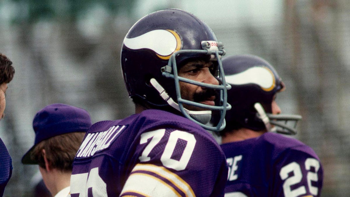 Jim Marshall looks on