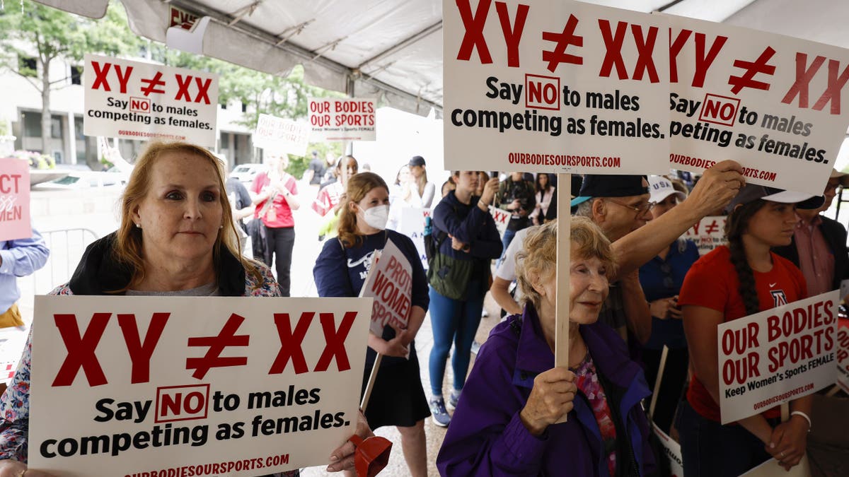 Protesters opposing trans athletes