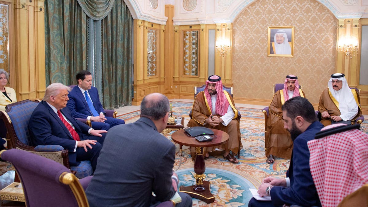 Syrian President Ahmed al-Sharaa meets with President Donald Trump and Saudi Crown Prince Mohammed Bin Salman and other officials in Riyadh, Saudi Arabia, in this handout released on May 14, 2025. 