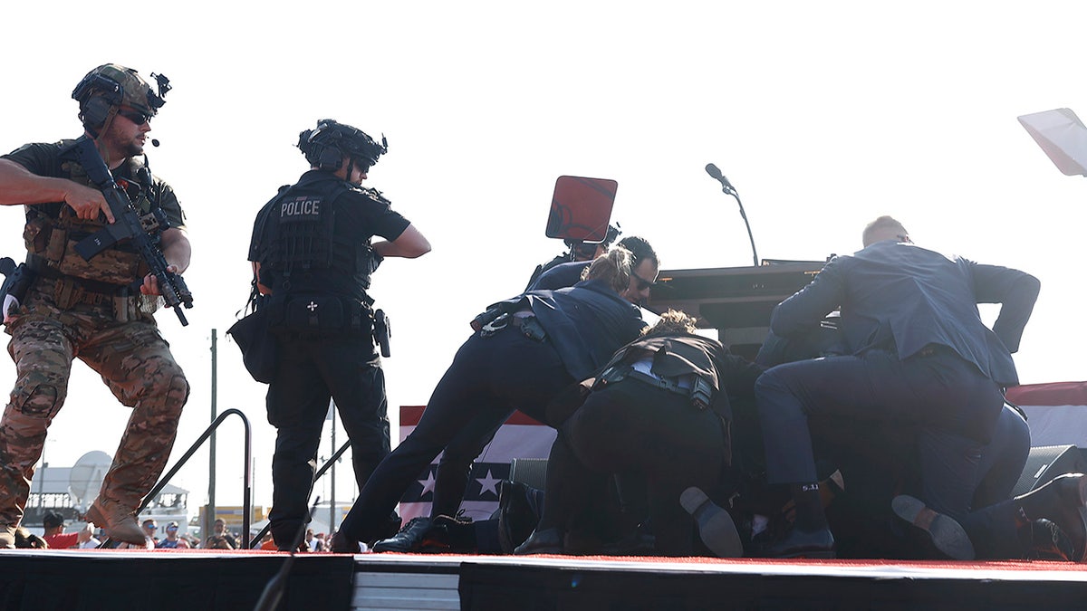 President Donald Trump is rushed offstage during a rally