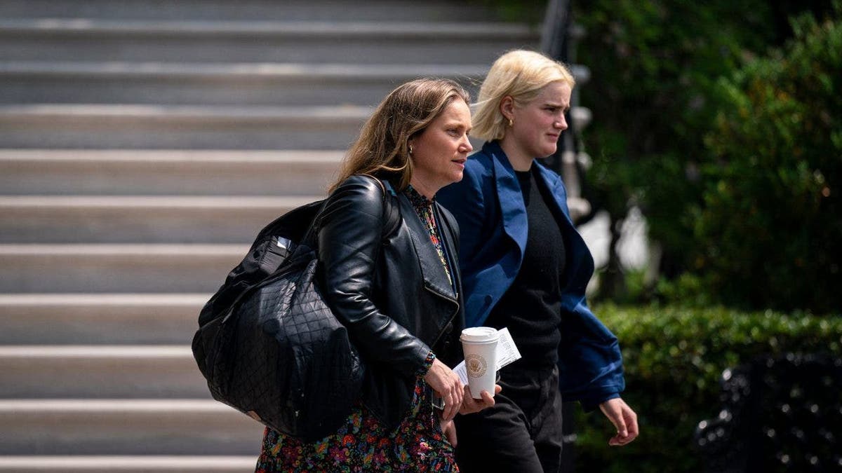 Annie Tomasini, left, walking near President Biden