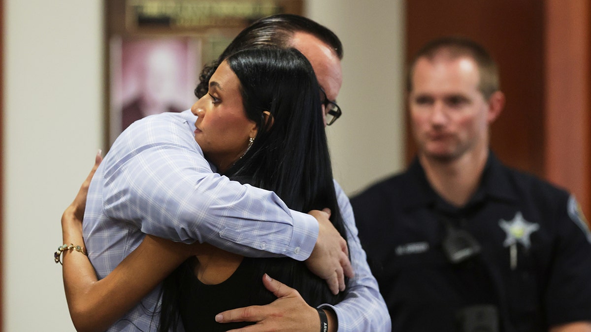 Idaho stabbing victim, Kaylee Goncalves's father and sister hug at the senrtencing hearing for Bryan Kohberger