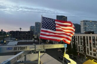 Patriotic ICE officer replaces American flag after protesters burned existing banner at Portland facility