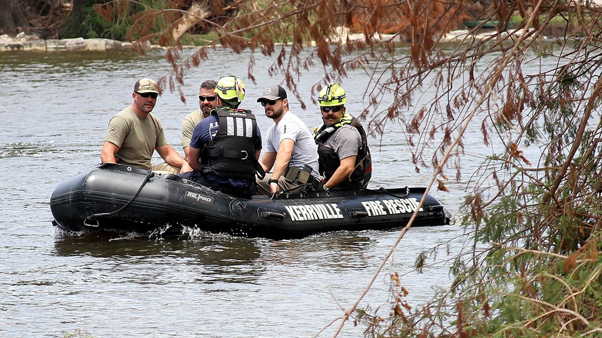 search team traveling down river in small boat