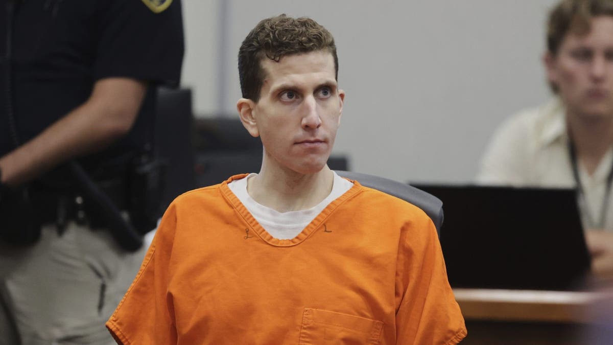 Kohberger leans back in courtroom wearing an orange jail jumpsuit
