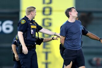 Security tackles baseball fan after he ran onto field, interrupting Astros-Orioles game