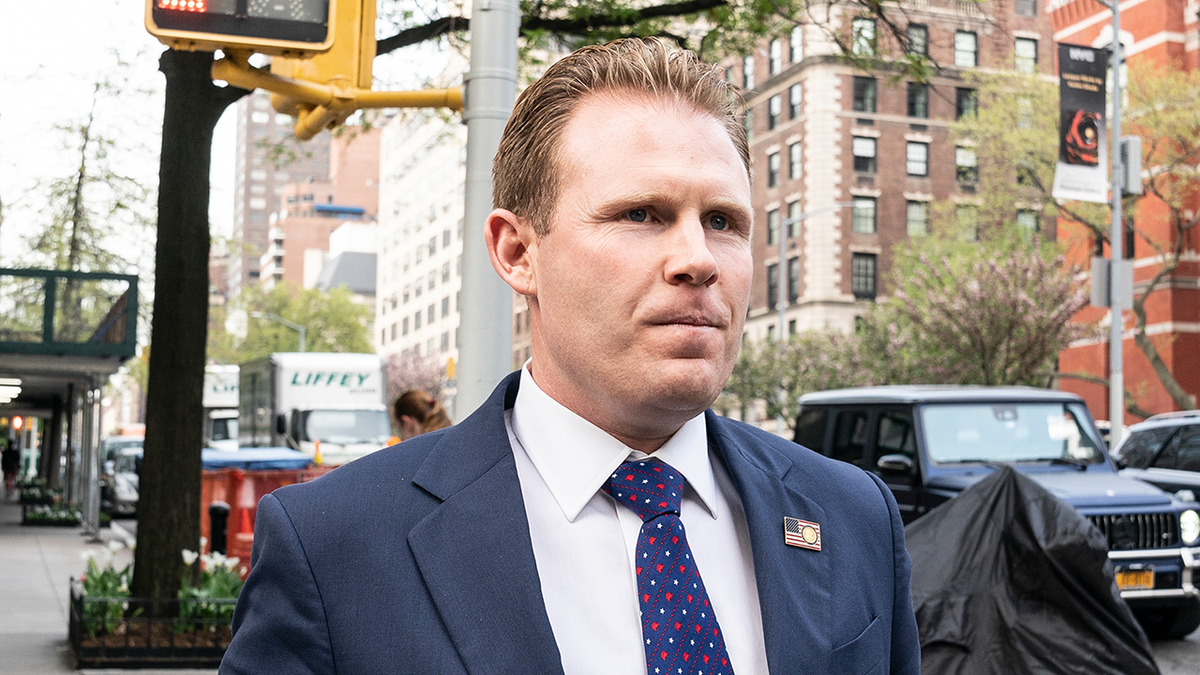 Andrew Giuliani walks on the street after leaving his father Rudy Giuliani's apartment in 2021. 