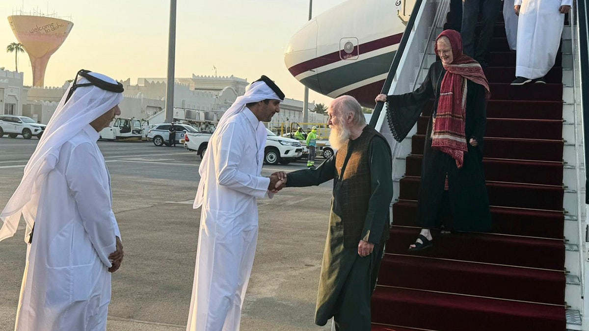 Couple getting off plane in Qatar