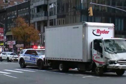 Truck hits parked van in Midtown Manhattan, pushing vehicle onto sidewalk and injuring 9