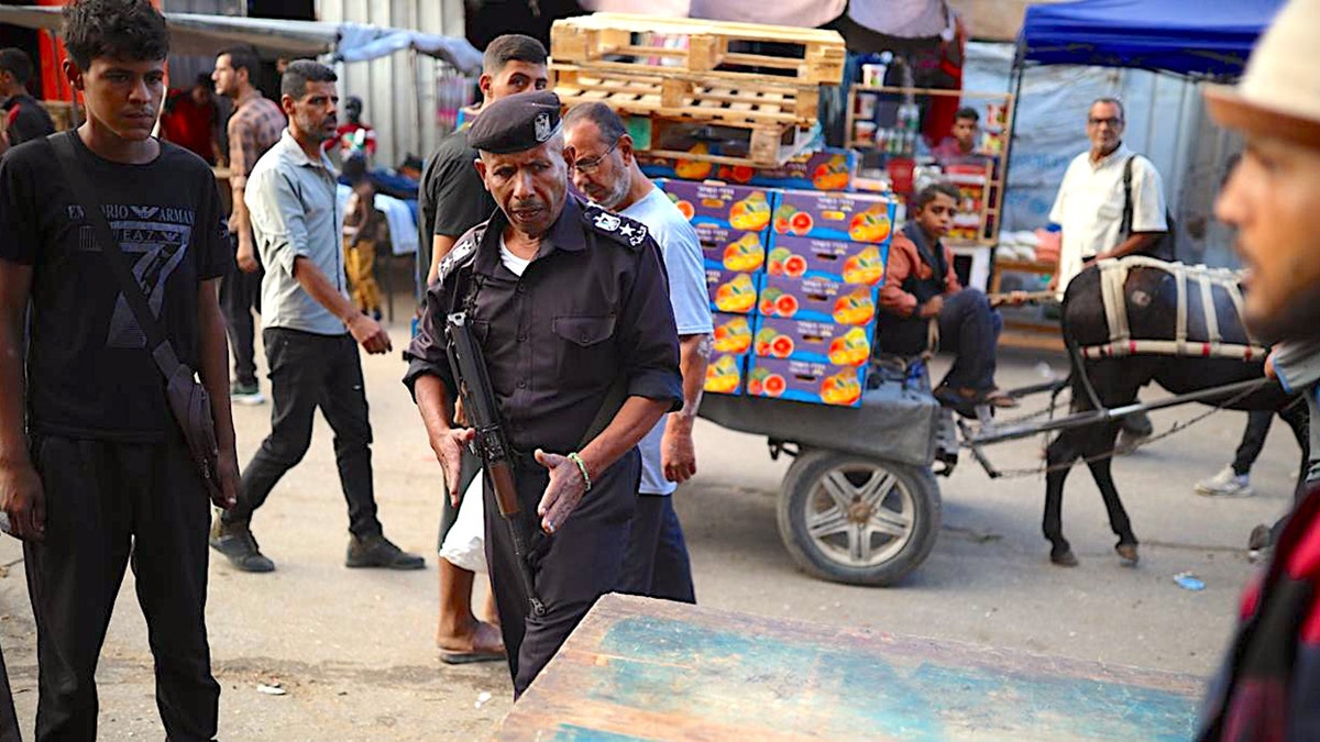 A Hamas police officer walks through a market in central Gaza.