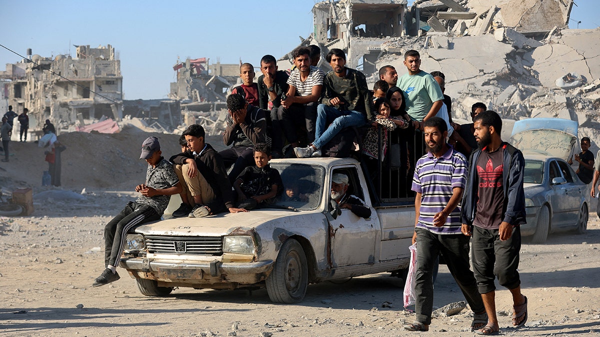 Palestinians travel on vehicle to neighborhood in Khan Younis