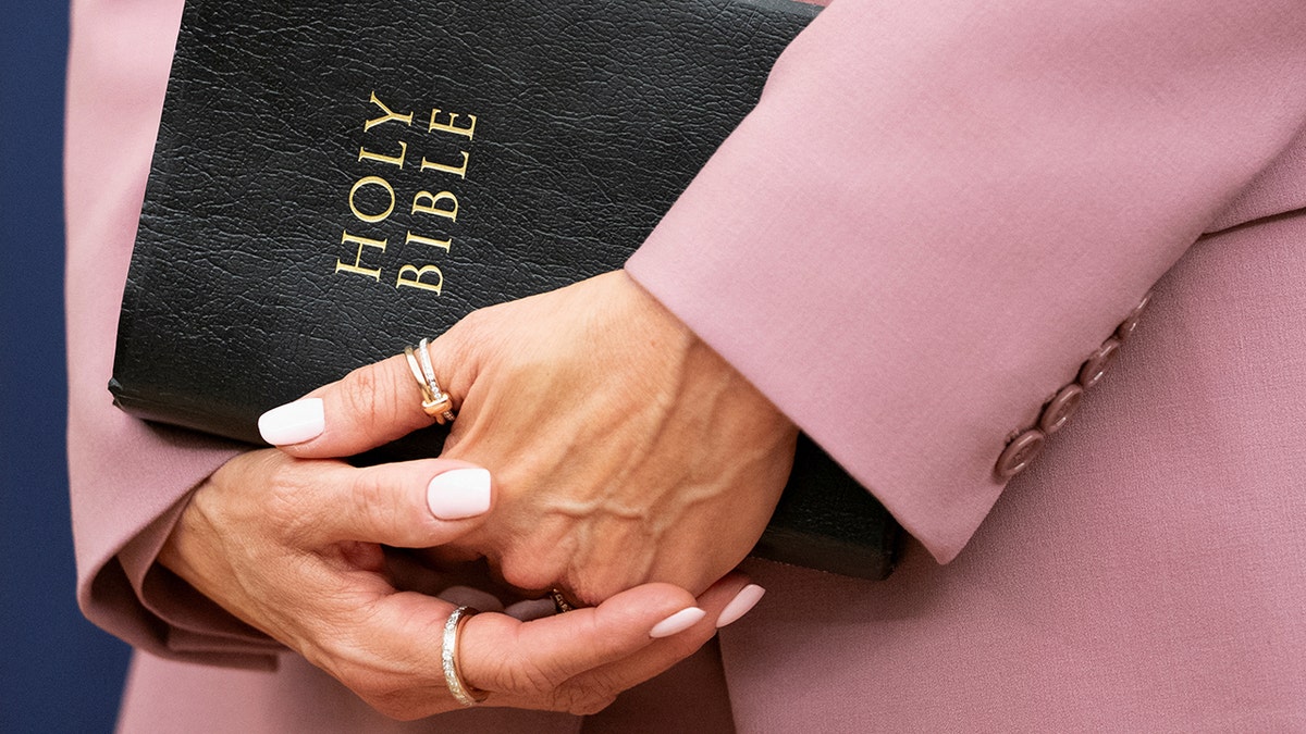 Allison Lutnick holds bible during swearing in ceremony